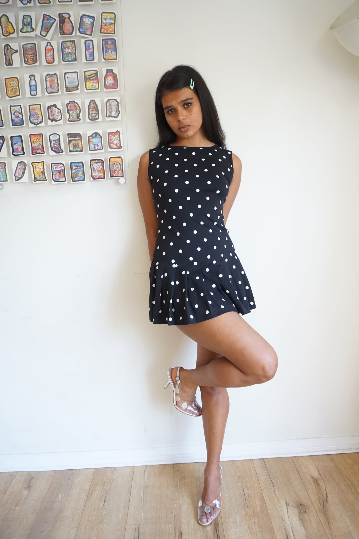 Girl wearing a drop waist black and white polka dot dress