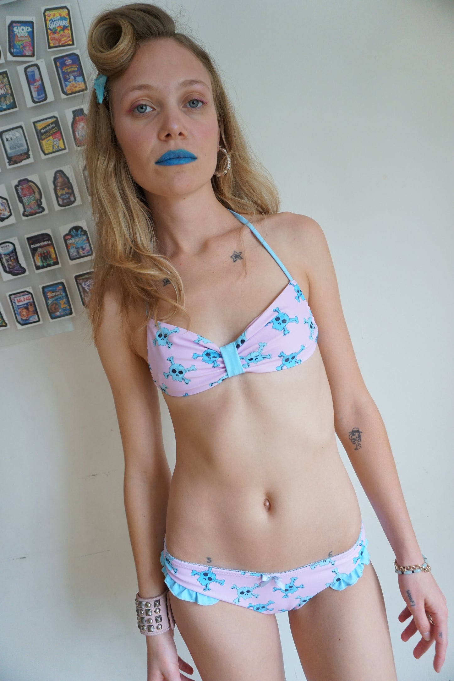 girl wearing pink bikini with blue skull pattern