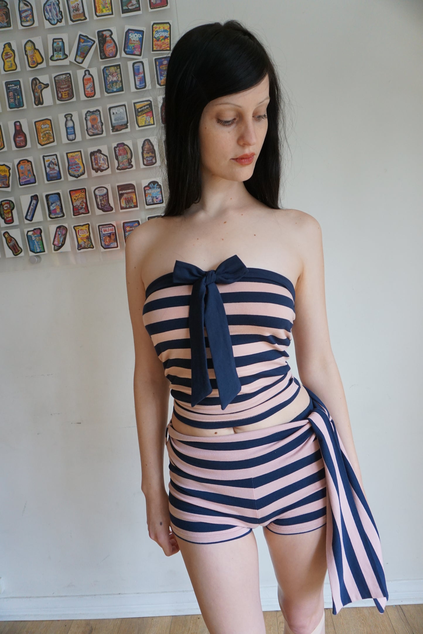 Woman wearing a pink and navy blue tube top and shorts set