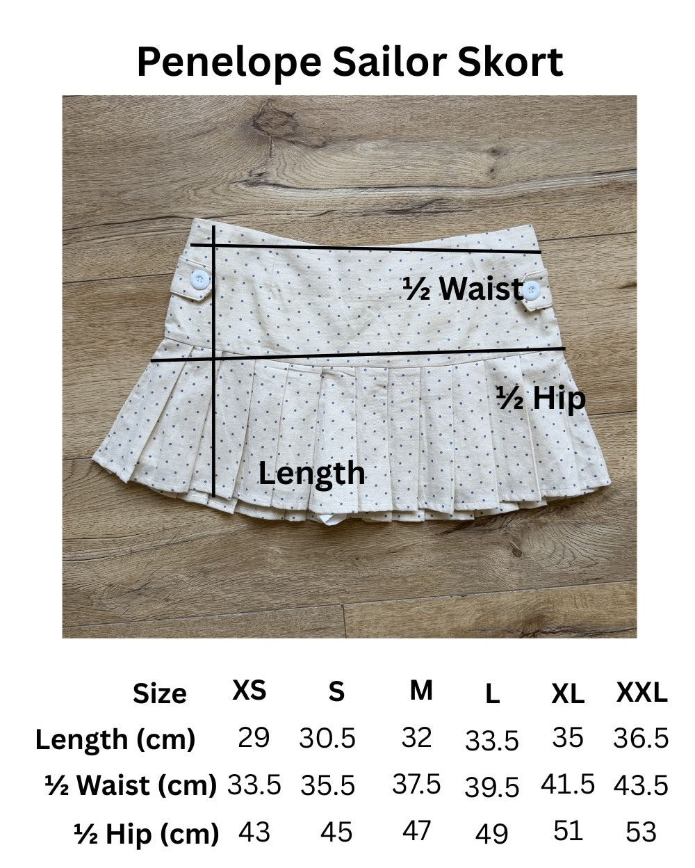 size chart for cream pleated skirt with blu polka dots and blue graphic t shirt