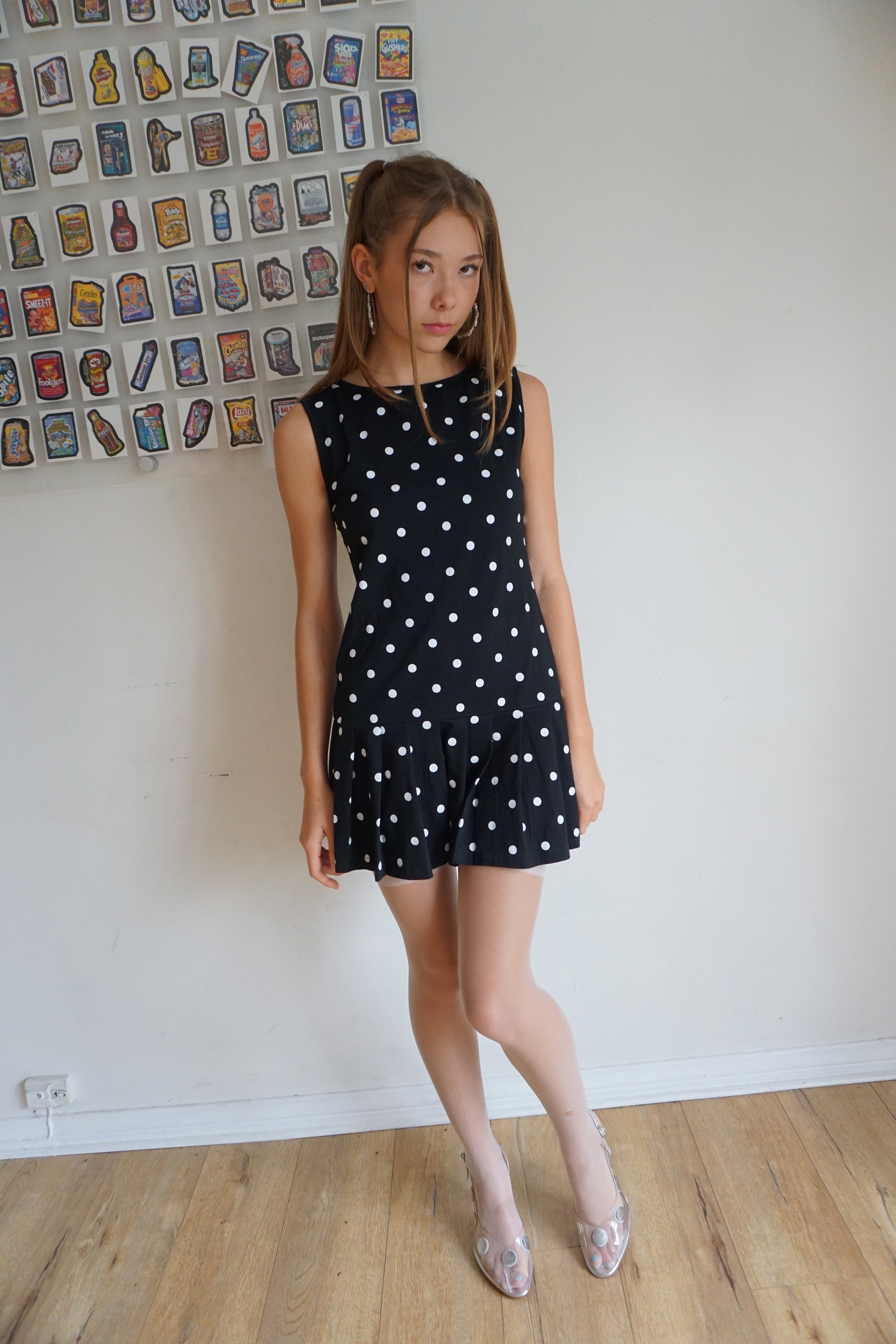 Girl wearing a pleated  drop waist black and white polka dot dress