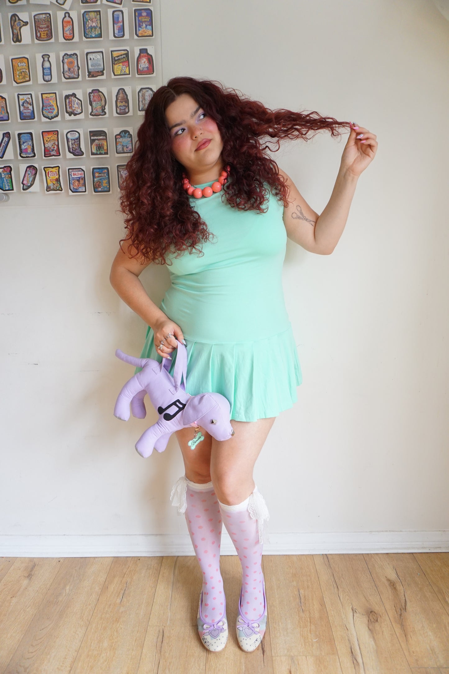 girl wearing a mint green drop waist pleated dress