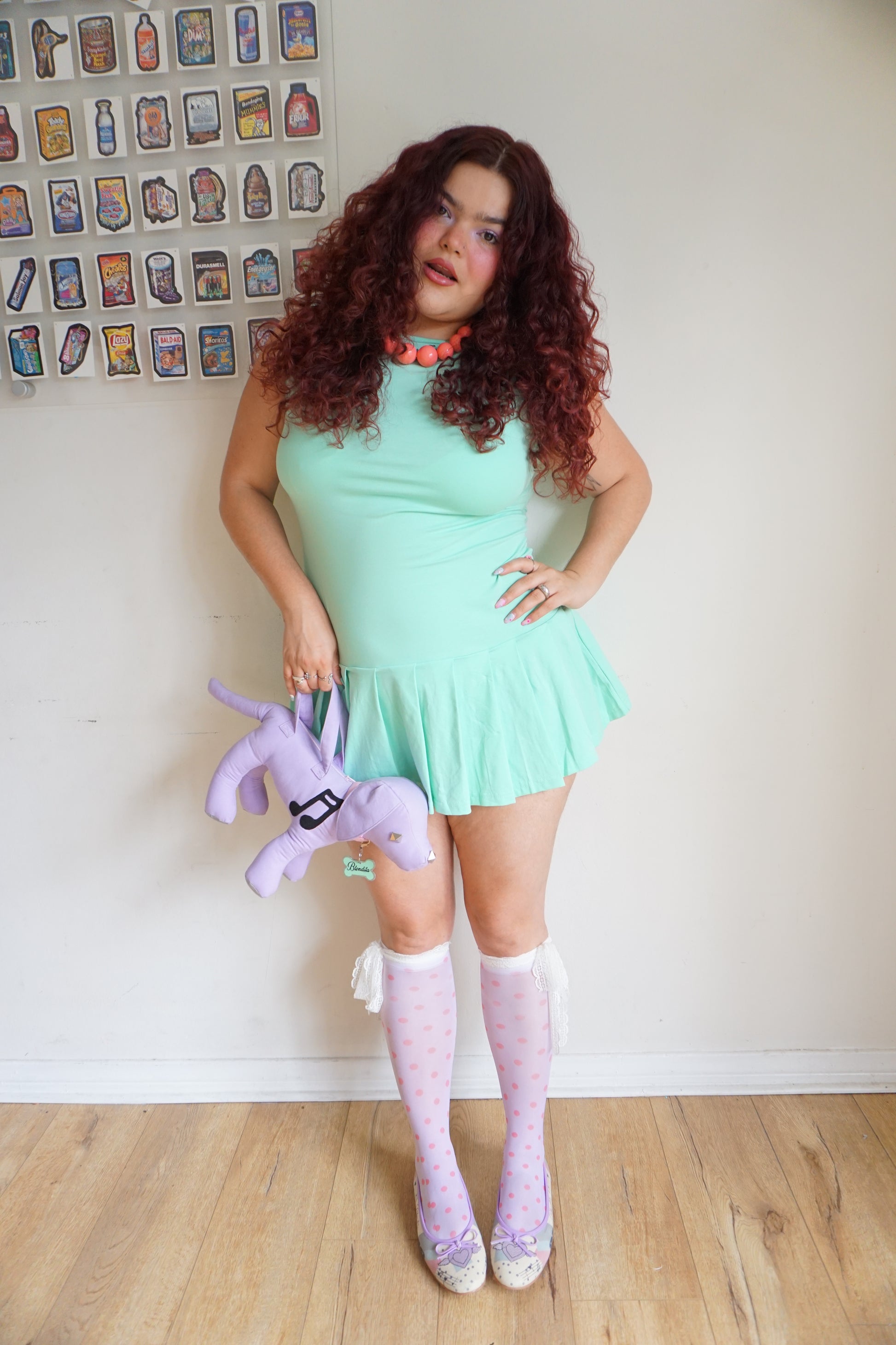 girl wearing a mint green drop waist pleated dress