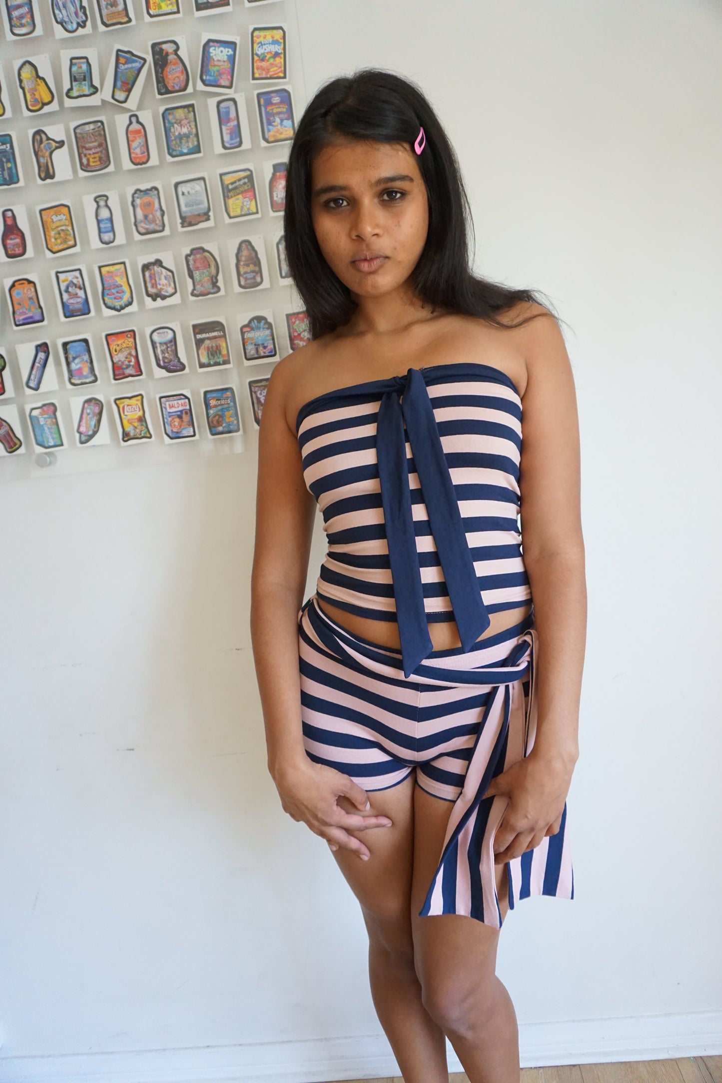 Woman wearing a pink and navy blue tube top and shorts set