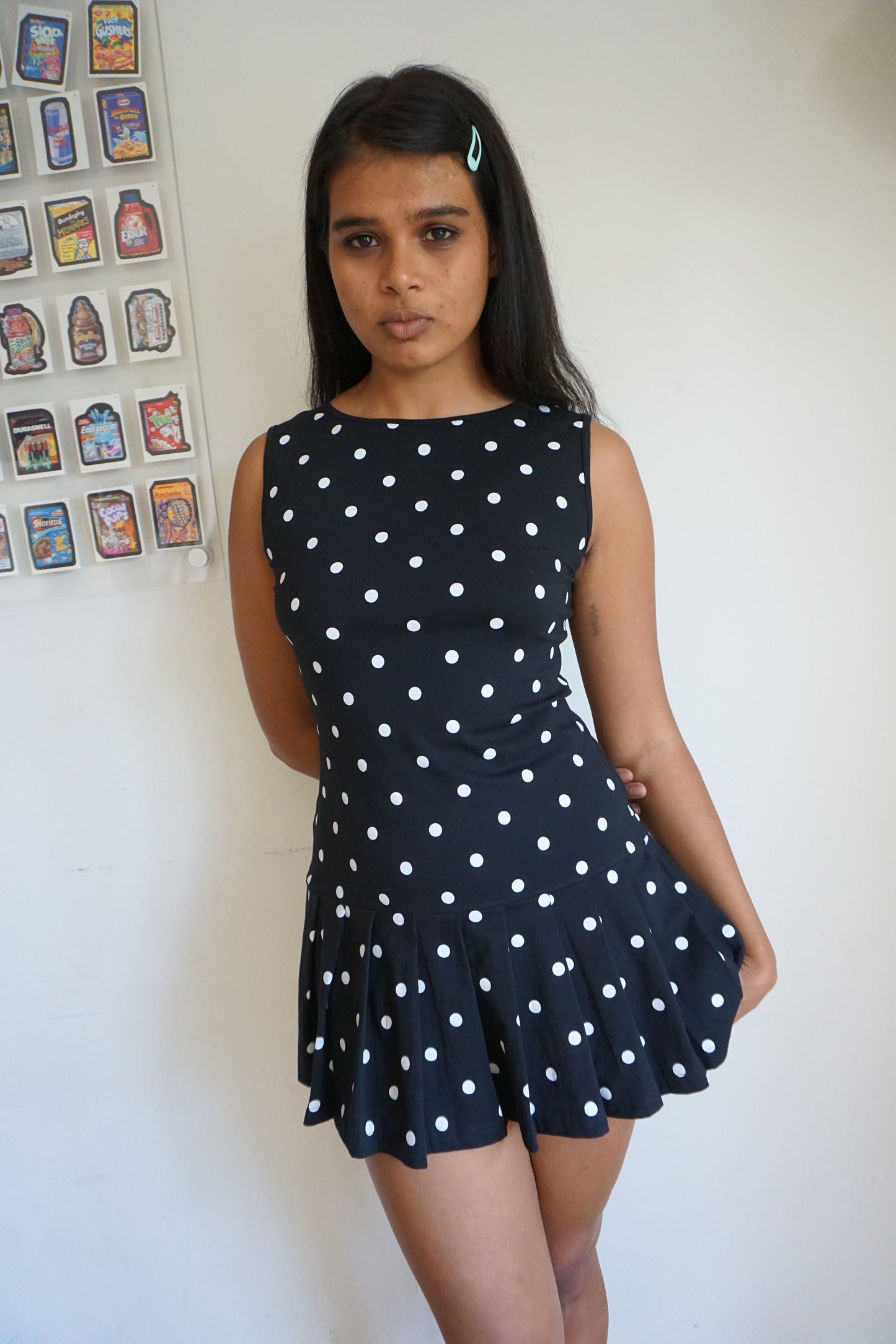 Girl wearing a drop waist black and white polka dot dress