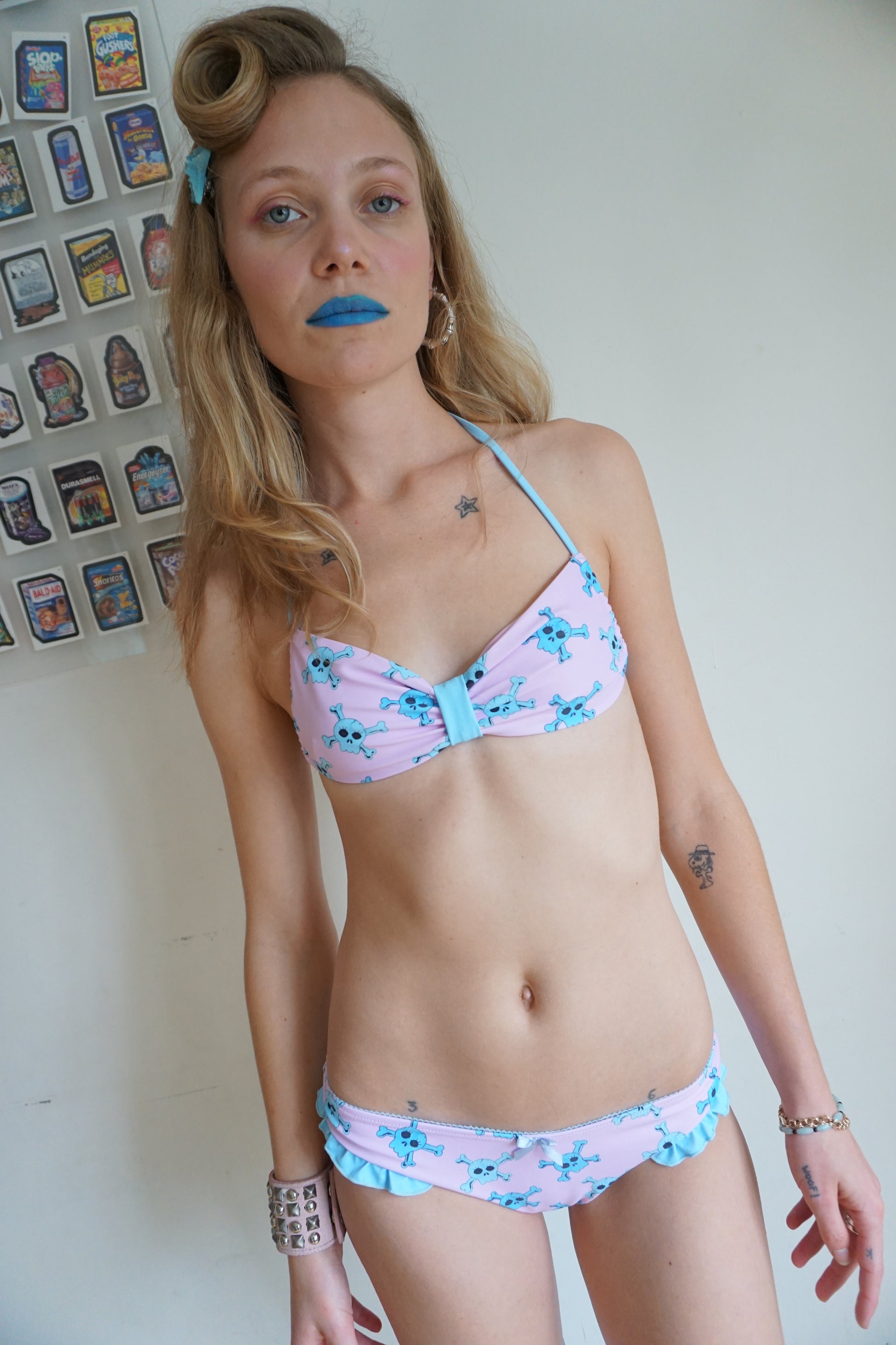 girl wearing pink bikini with blue skull pattern