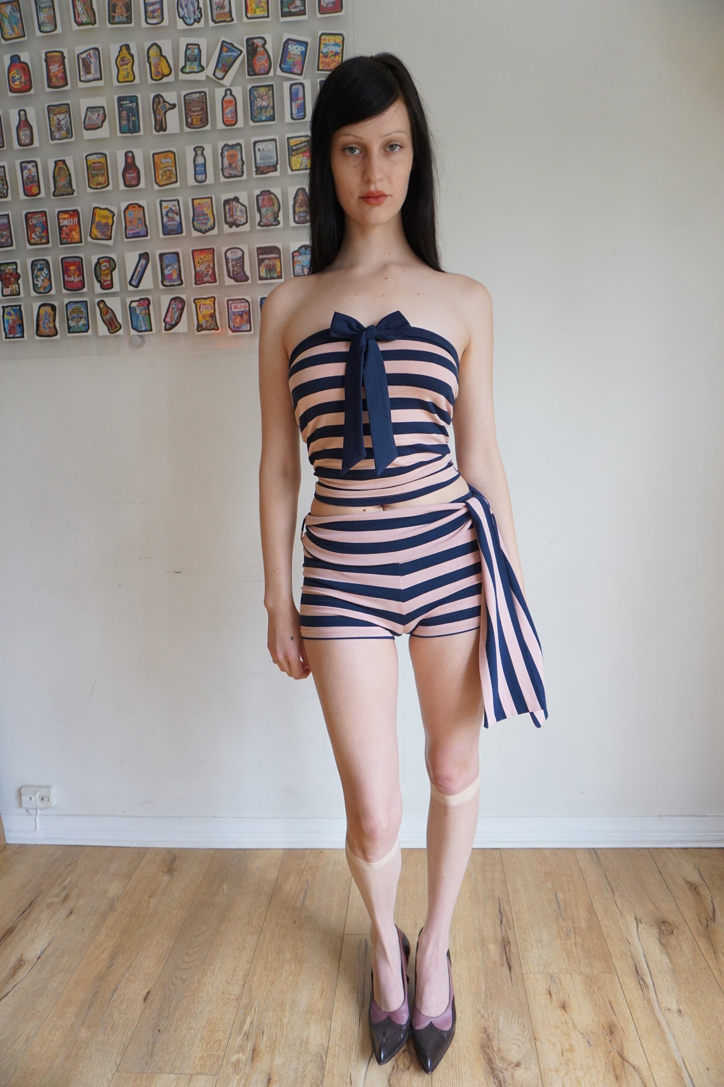 Woman wearing a pink and blue tube top and shorts set
