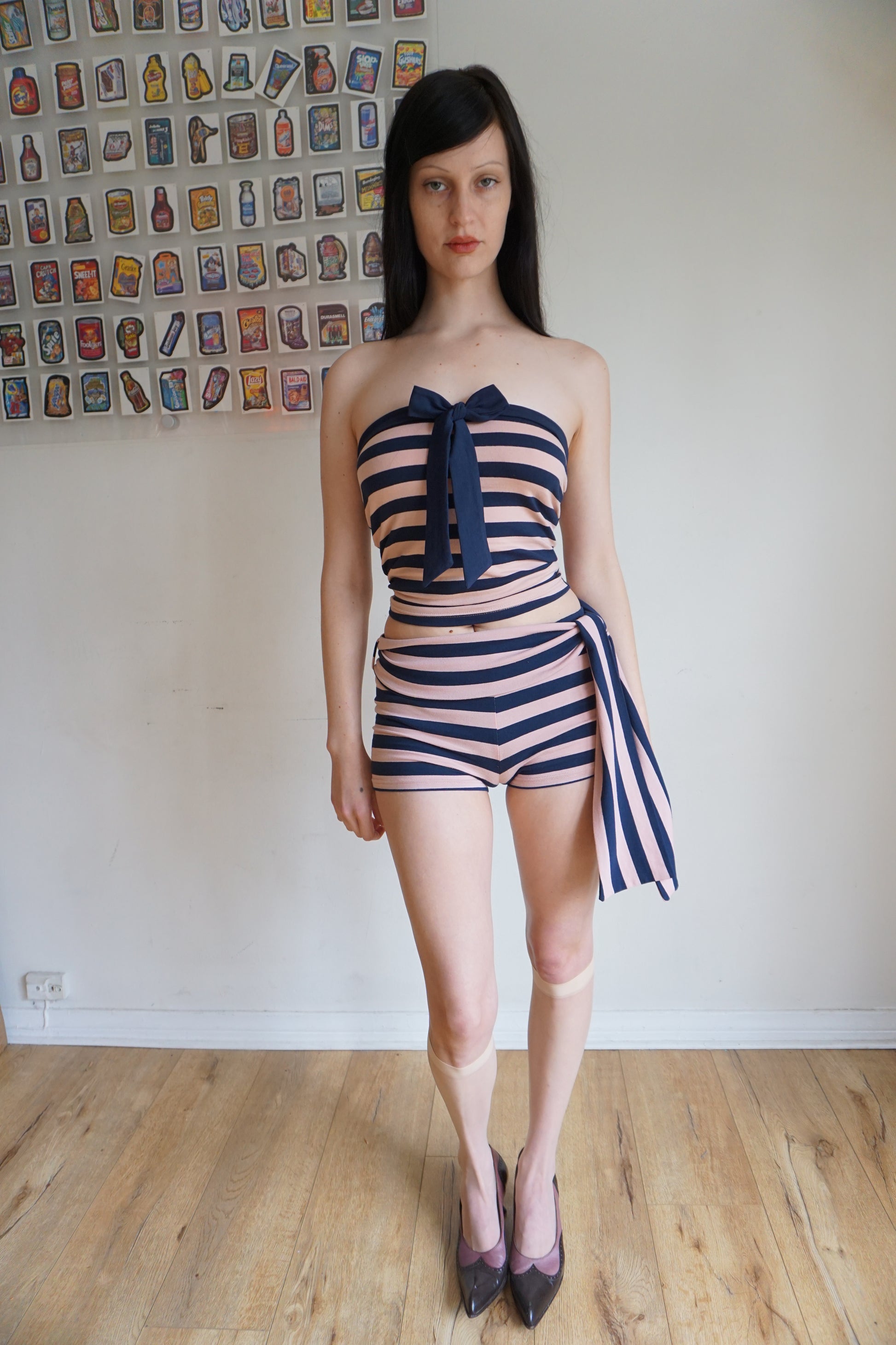 Woman wearing a pink and blue tube top and shorts set