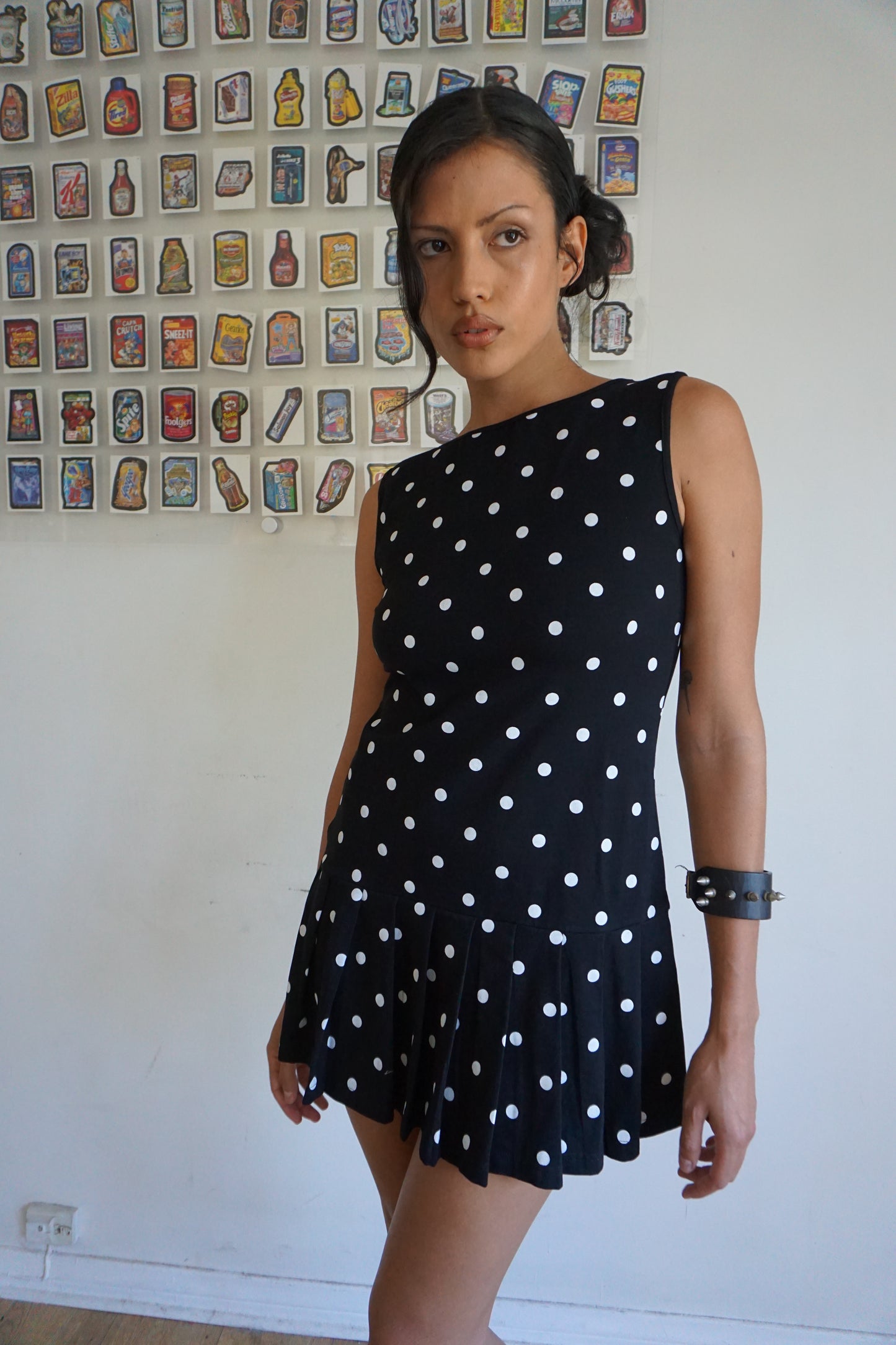 Girl wearing a drop waist black and white polka dot dress