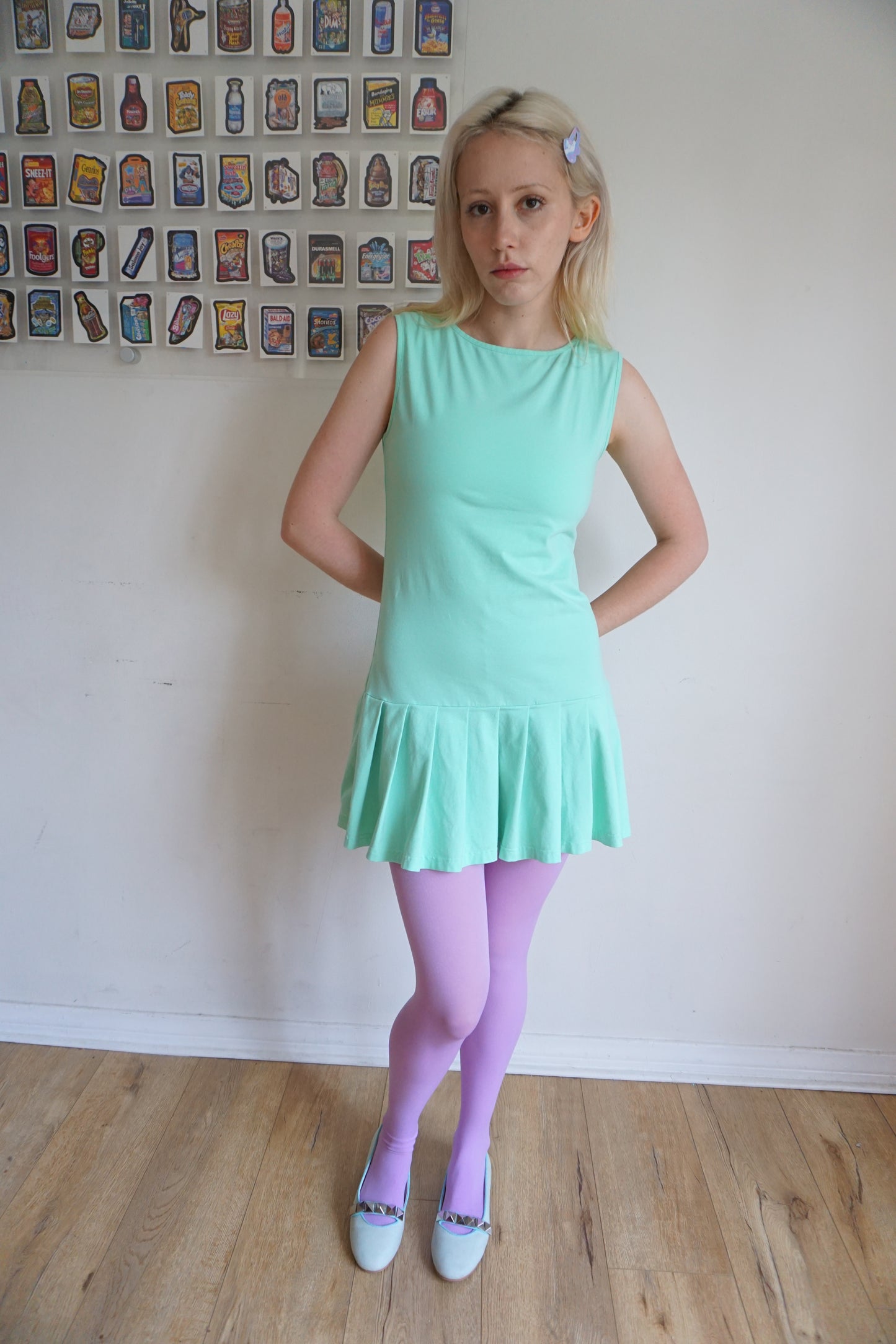 girl wearing a mint green drop waist pleated dress