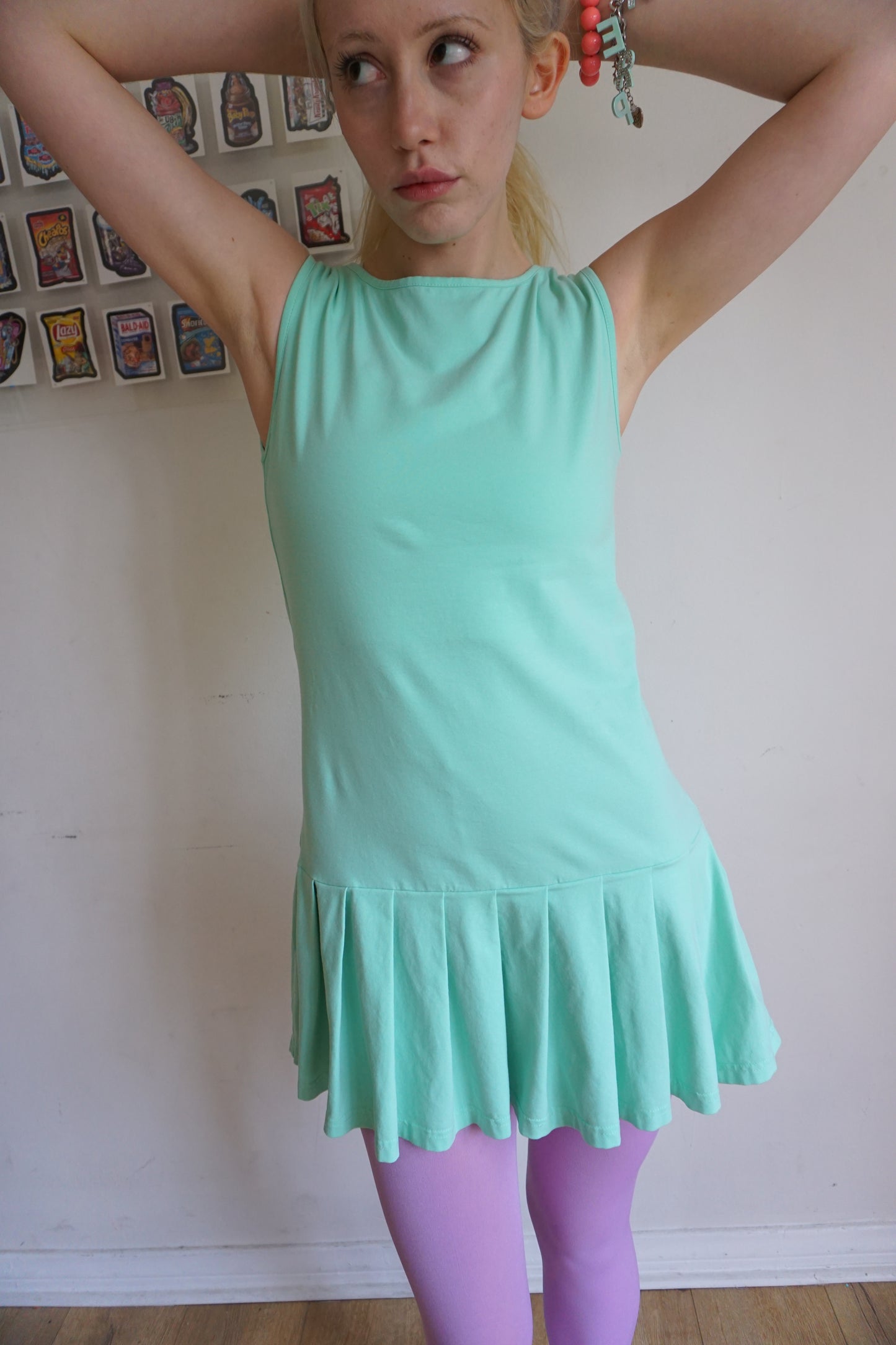 girl wearing a mint green drop waist pleated dress