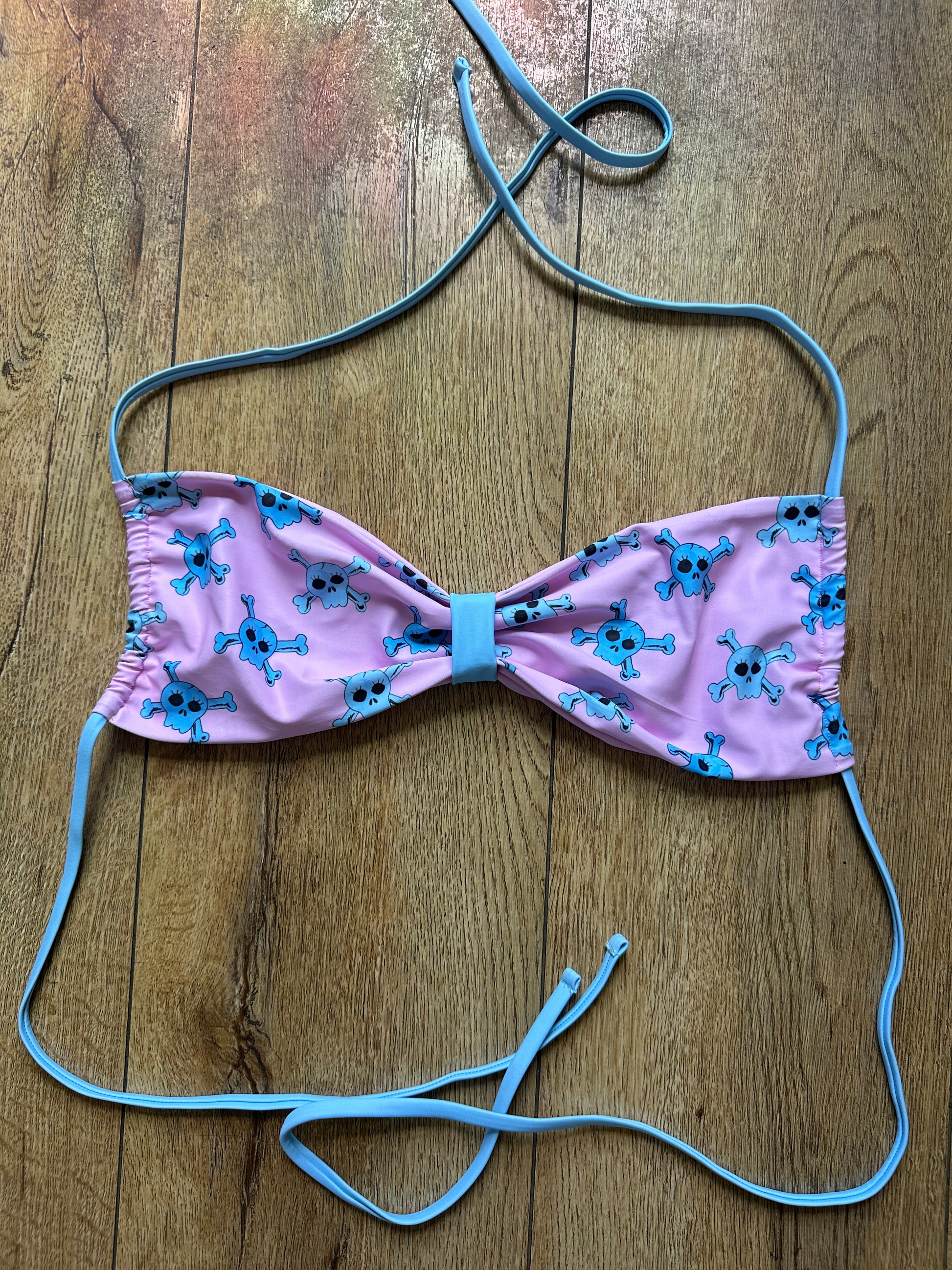  pink bikini top with blue accents and blue skull pattern
