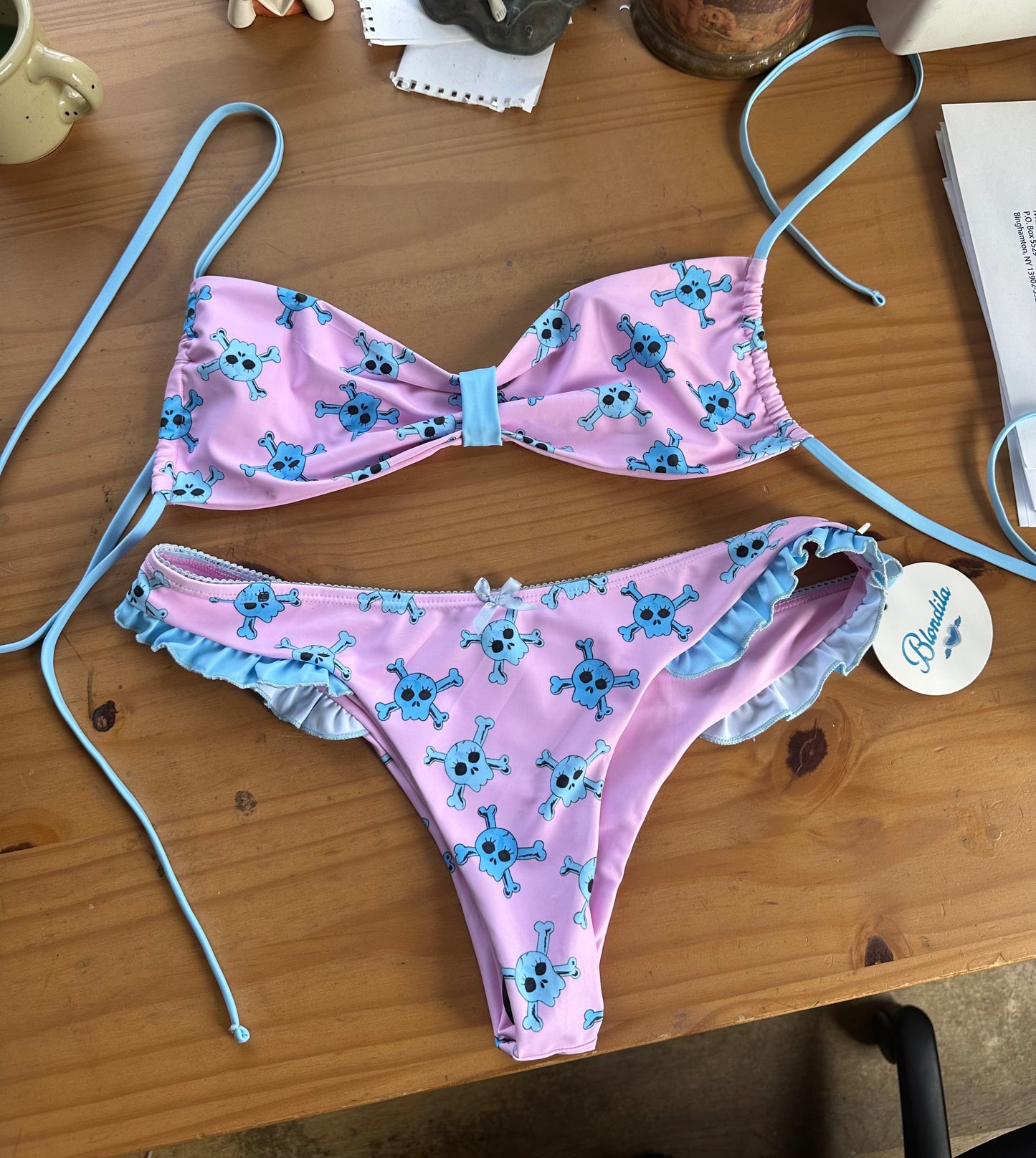  pink bikini top with blue accents and blue skull pattern