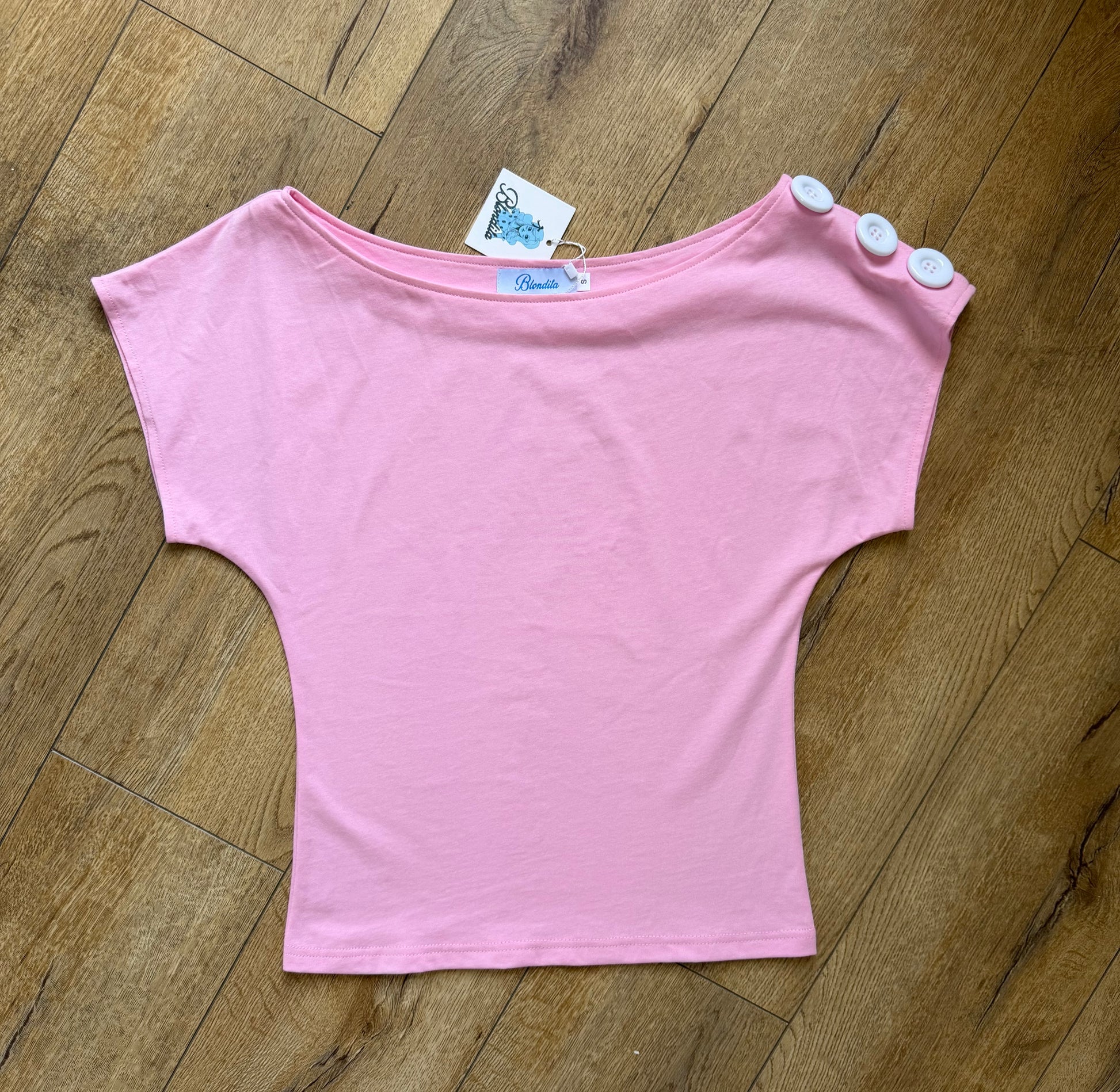  pink off the shoulder top with buttons on the sleeves 