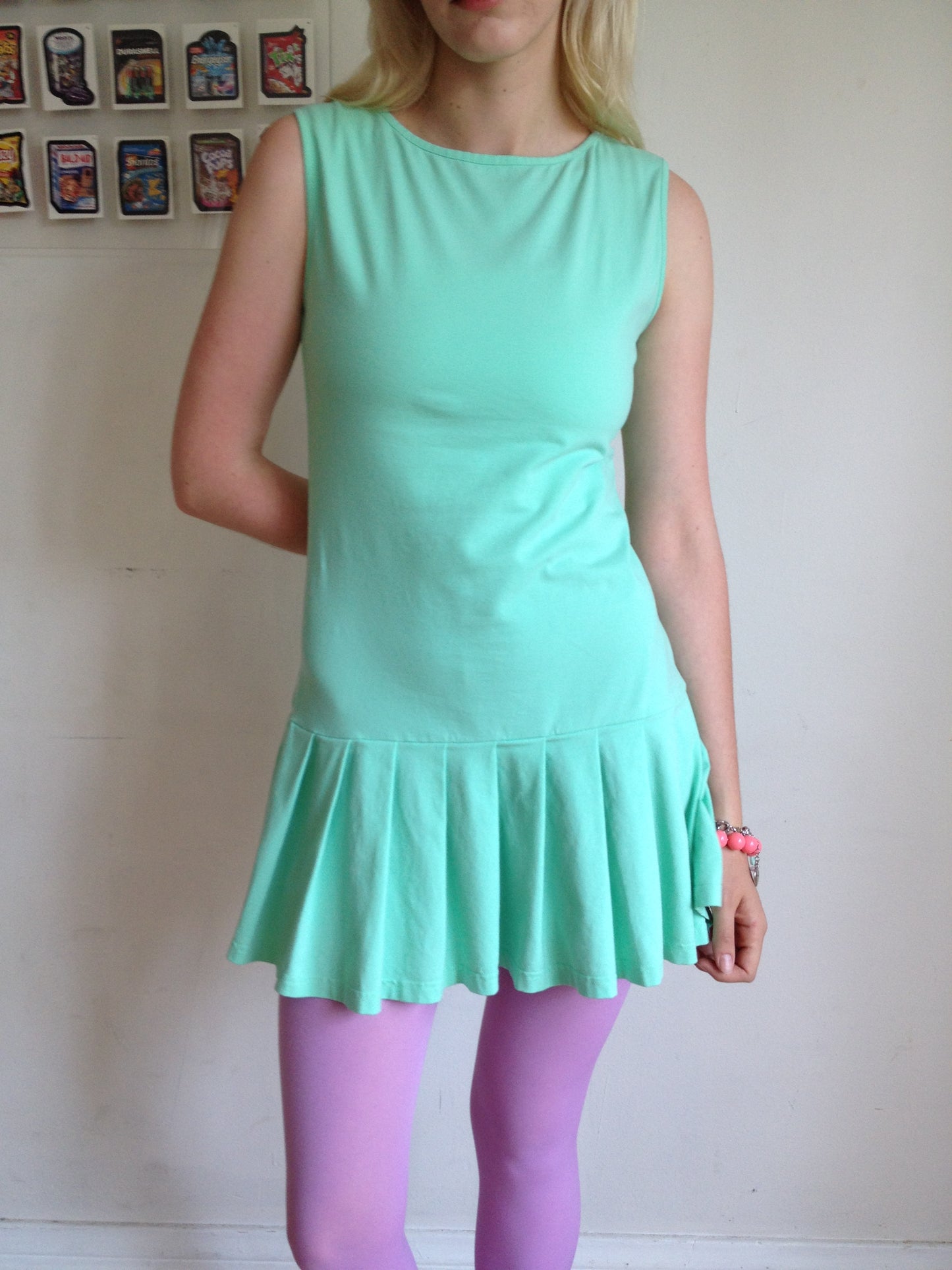 girl wearing a mint green drop waist pleated dress