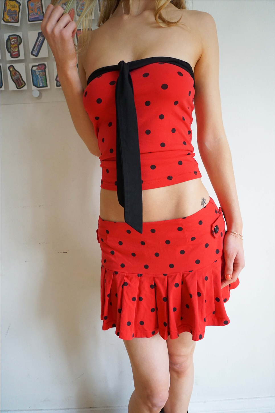 pleated red skirt with black polka dots and buttons on the side